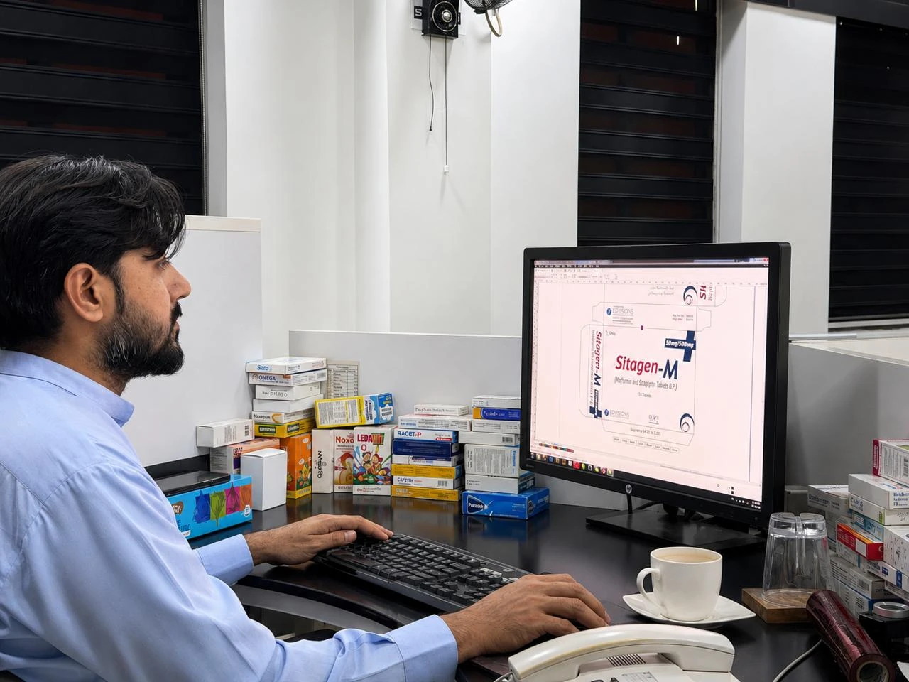 Designer preparing carton artwork on a computer.